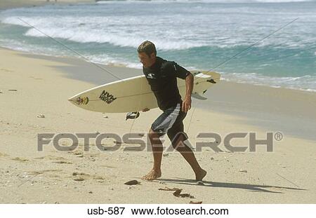 Surfer Walking up Beach Hawaii USA View Large Photo Image Stock Photo - Surfer Walking up Beach Hawaii USA. Fotosearch