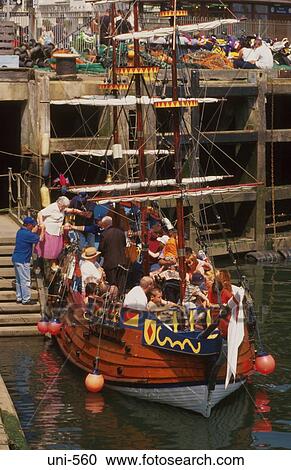 Stock Image - Tourists Boarding Fake Galleon for Day Trip UK. Fotosearch