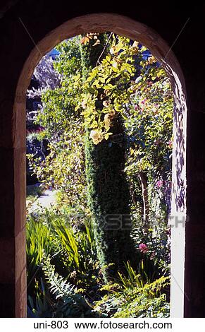 Stock Image - View through Arch of Gardens Portmeirion Wales UK. Fotosearch