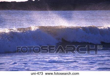 Stock Image - Wave Approaching Shore Wales. Fotosearch