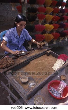 Stock Photography - Woman Bundling Incense Sticks Vietnam. Fotosearch
