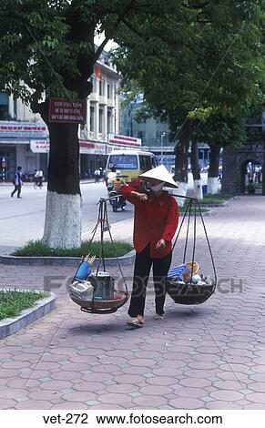 Stock Image - Woman with Yoke Hanoi Vietnam. Fotosearch