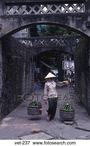 Woman with Yoke in Old City Gate Hanoi Vietnam View Large Photo Image Stock Photo - Woman with Yoke in Old City Gate Hanoi Vietnam. Fotosearch
