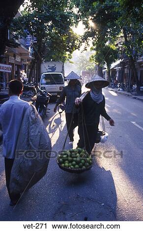 Stock Image - Women Carrying Fruit Hanoi Vietnam. Fotosearch