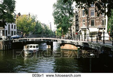 Stock Image - ARCH, Canal, Bridge, Boat, Amsterdam. Fotosearch