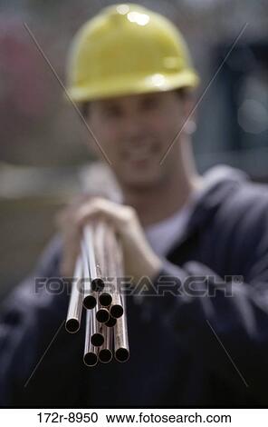 Stock Image - blur, industry, construction, smiling, worker, carrying. Fotosearch