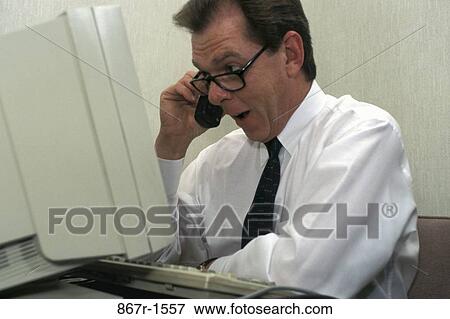 Stock Photo - desk, telephone, eyeglasses, computer, phone. Fotosearch