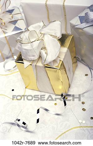 gold, celebration, confetti, gift, present, ribbon, elegant View Large Photo Image Stock Photo - gold, celebration, confetti, gift, present, ribbon, elegant. Fotosearch