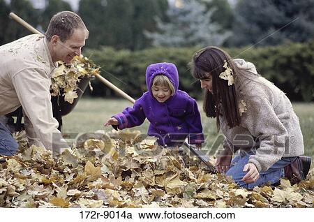 Stock Image - leaves, people, autumn, playing, laughing, outdoors. Fotosearch