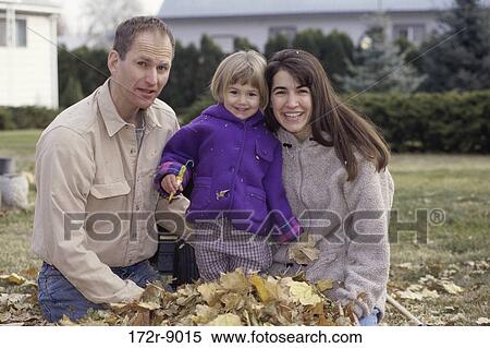Stock Photography - leaves, people, smiling, outdoors, family, daughter. Fotosearch