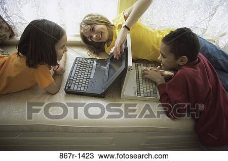 Stock Image - multiethnic, people, home, computer, friends, laptops. Fotosearch