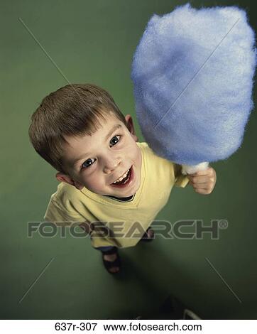 Stock Photo - people, eating, excitement, excited, blue, holding, boy. Fotosearch