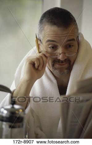 Stock Photo - people, eyeglasses, reading, Middle-aged, indoors. Fotosearch