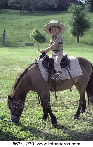 people, hat, riding, boy, outdoors, child, ride View Large Photo Image Stock Image - people, hat, riding, boy, outdoors, child, ride. Fotosearch