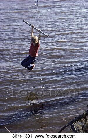 Stock Image - people, lake, swinging, swing, boy, outdoors, child. Fotosearch