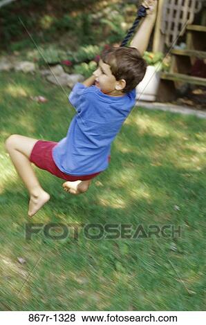Stock Photo - people, rope, swinging, swing, boy, outdoors, child. Fotosearch