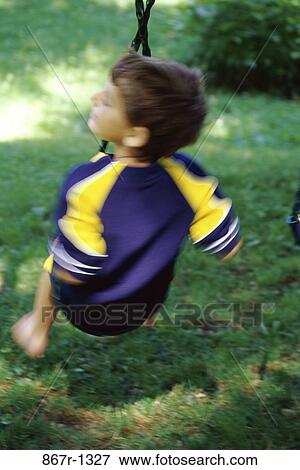 people, swinging, swing, boy, outdoors, child, brunette View Large Photo Image Stock Photo - people, swinging, swing, boy, outdoors, child, brunette. Fotosearch
