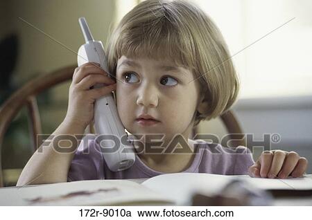 Stock Image - people, telephone, table, talking, listening, phone, holding. Fotosearch