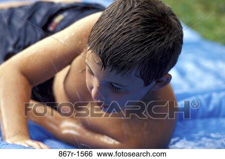 people, water, playing, sliding, boy, outdoors View Large Photo Image Stock Photograph - people, water, playing, sliding, boy, outdoors. Fotosearch
