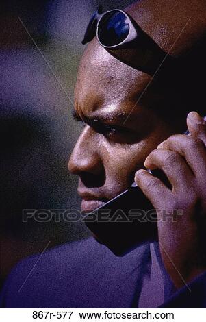 Stock Photo - profile, talking, phone, sunglasses, business, outdoors. Fotosearch