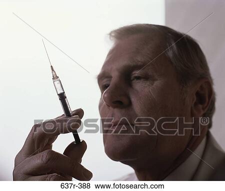 Stock Photo - senior, needle, syringe, doctor, injection. Fotosearch