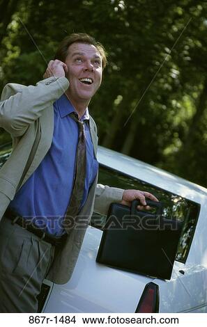 Picture - telephone, briefcase, talking, phone, business, outdoors, Middle-aged. Fotosearch