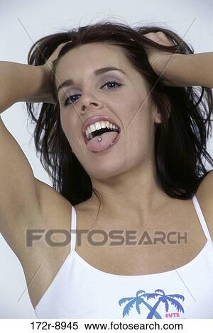 Stock Photography - woman, mouth, tongue, body parts, piercing, brunette. Fotosearch