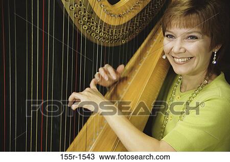 woman, smiling, playing, music, arts, entertainment View Large Photo Image Stock Image - woman, smiling, playing, music, arts, entertainment. Fotosearch