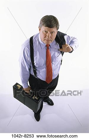 Stock Image - briefcase, business, Middle-aged, serious, suspenders, businessman. Fotosearch