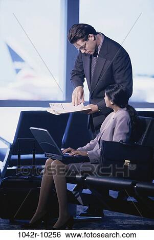 Stock Photograph - briefcase, Hispanic, laptop, business, indoors, travel, airport. Fotosearch