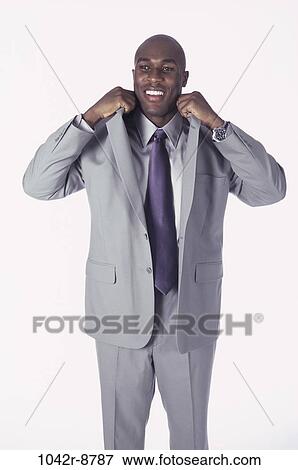 Stock Photo - business, businessman, indoors, African-American, young adult, cutout. Fotosearch