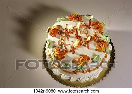 Stock Image - cake, decorated, birthday, lit, candles, food, still life. Fotosearch