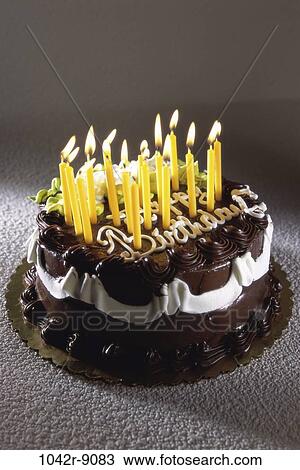 Stock Image - desert, chocolate, decorated, birthday, lit, candles, food. Fotosearch