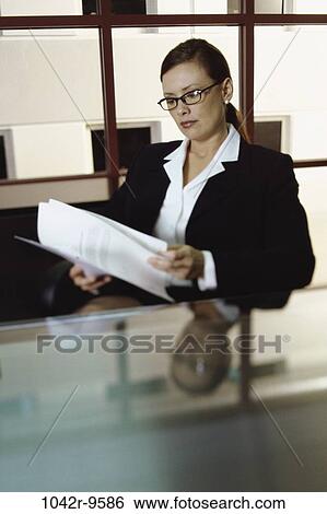 desk, woman, eyeglasses, reading, business, Middle-aged, indoors View Large Photo Image Stock Photograph - desk, woman, eyeglasses, reading, business, Middle-aged, indoors. Fotosearch