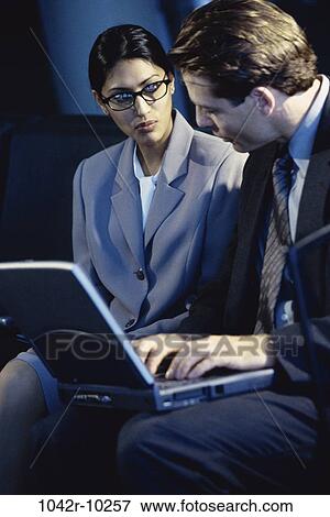 eyeglasses, Hispanic, laptop, business, indoors, businesspeople, young adult View Large Photo Image Stock Photo - eyeglasses, Hispanic, laptop, business, indoors, businesspeople, young adult. Fotosearch