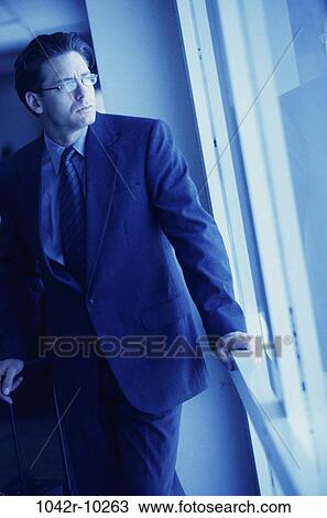 Stock Image - eyeglasses, window, business, contemplating, thinking, gazing. Fotosearch