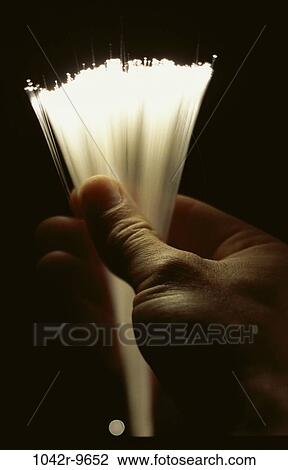 Stock Image - hand, industry, holding, communications, industrial, lights, fiber optics. Fotosearch
