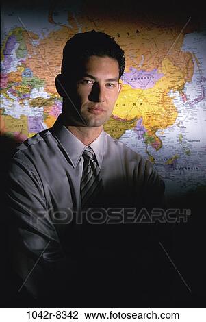 Stock Image - Hispanic, business, global, businessman, indoors, young adult. Fotosearch