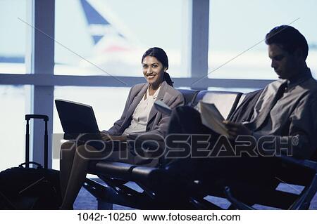 Hispanic, laptop, business, indoors, travel, airport, businesspeople View Large Photo Image Stock Image - Hispanic, laptop, business, indoors, travel, airport, businesspeople. Fotosearch