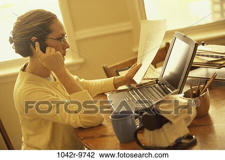 Stock Image - home, woman, telephone, talking, computer, laptop, phone. Fotosearch