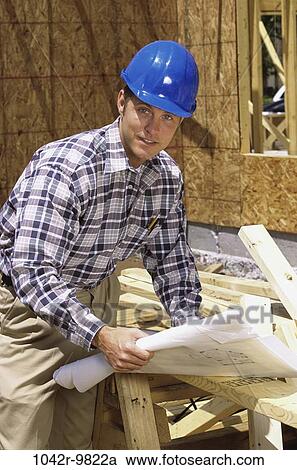 Stock Image - industry, construction, building, worker, blueprints, lumber. Fotosearch