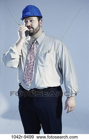 Stock Photo - industry, construction, talking, worker, Middle-aged, radio. Fotosearch