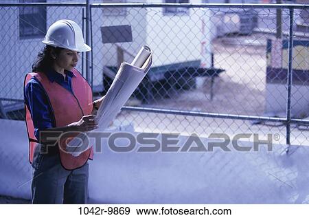 industry, construction, woman, reading, worker, Middle-aged, looking View Large Photo Image Stock Photo - industry, construction, woman, reading, worker, Middle-aged, looking. Fotosearch