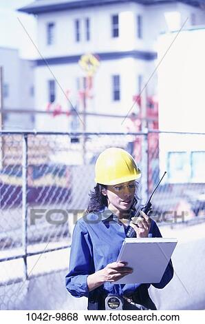 Stock Photo - industry, construction, woman, talking, reading, worker, plans. Fotosearch