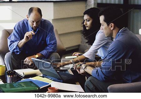 Stock Image - meeting, group, multiethnic, coworkers, talking, conversation, computer. Fotosearch