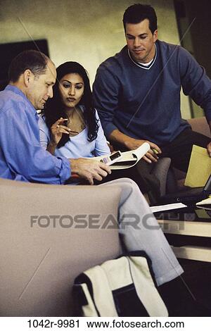 Stock Image - meeting, group, multiethnic, coworkers, talking, discussion, conversation. Fotosearch