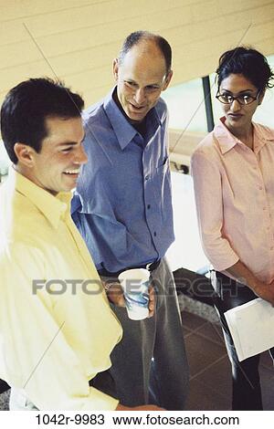 Stock Image - meeting, group, multiethnic, coworkers, talking, discussion, conversation. Fotosearch