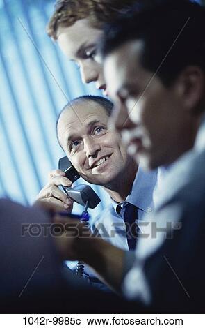 Stock Image - meeting, group, multiethnic, men, woman, telephone, phone. Fotosearch