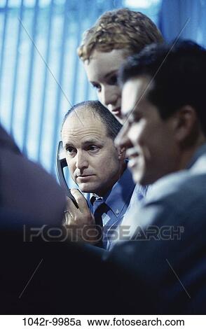 Stock Image - meeting, group, multiethnic, telephone, coworkers, talking, discussion. Fotosearch