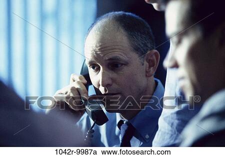 Stock Image - meeting, men, telephone, talking, listening, conversation, phone. Fotosearch
